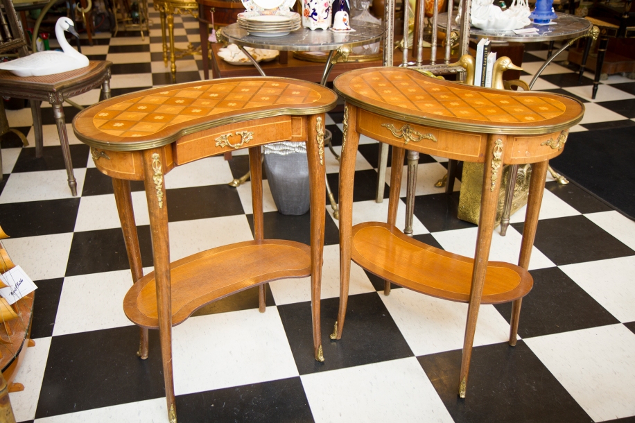 $1,395. Pair of antique French kidney form side tables with inlay depicting four leaf clovers and gilt metal mounts and drawer pull. Circa 1900.